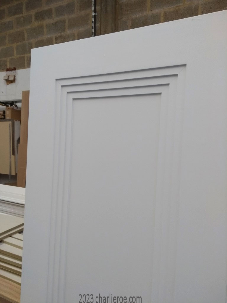 new bespoke Art Deco wood interior door with a primed finish showing the panel moulding