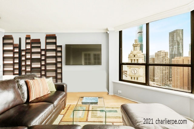 New Paul Frankl Art Deco Skyscraper style painted lacquered bookcase in black with silver edges shown in a Chicago condo