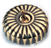 Arts & Crafts Movement style antique brass fluted single domed nipple electric light switch