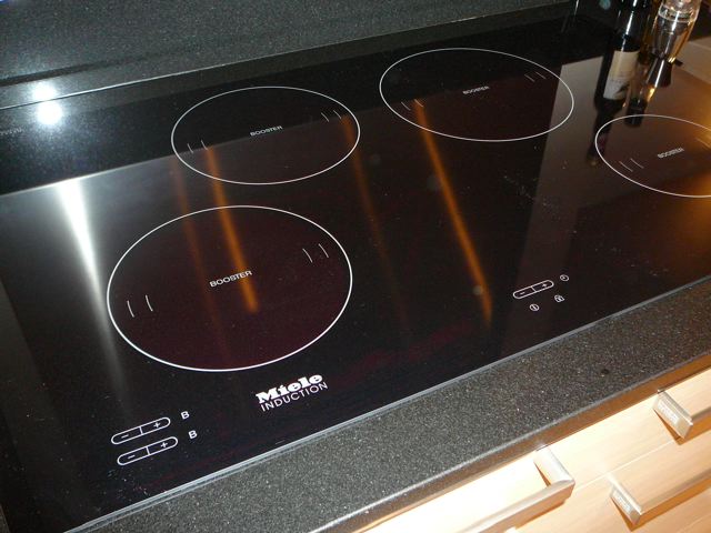 Miele black glass induction hob on black granite worktop