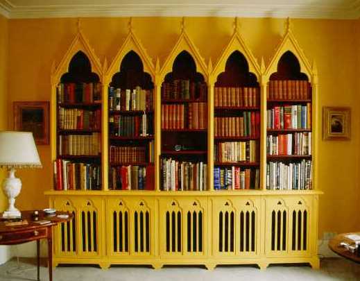 Gothic Gothique wooden double bookcases either side of a fireplace
